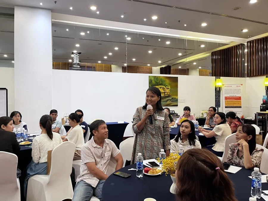 A group of Vietnamese women and men attending a training session.