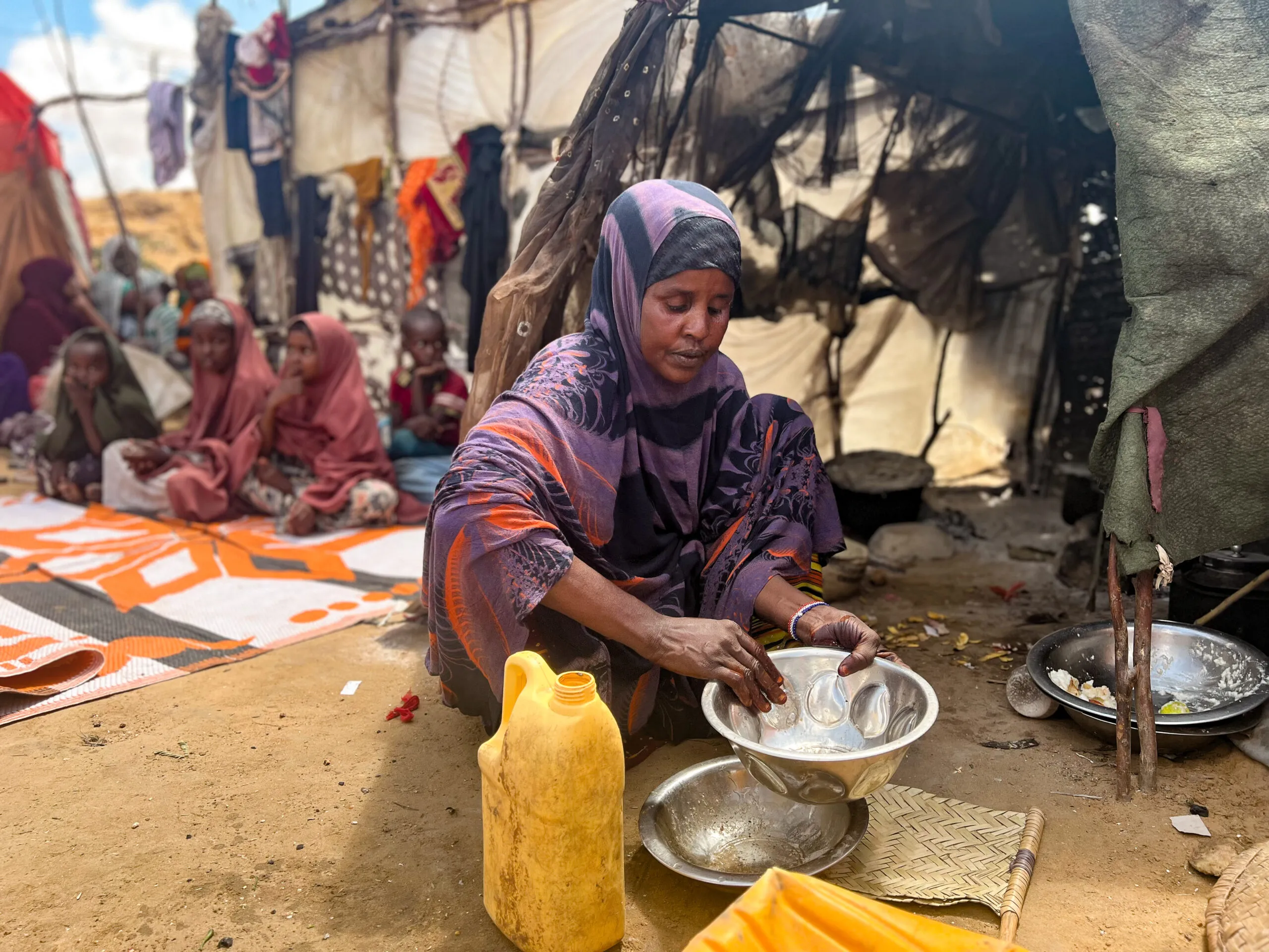 Woman washing dishes in a Somali refugee camp