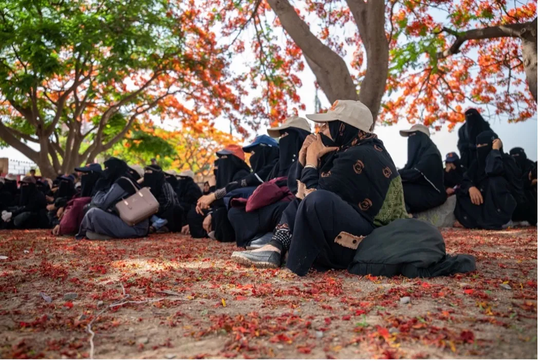 A group of veiled women participate in an agricultural education session in Yemen.